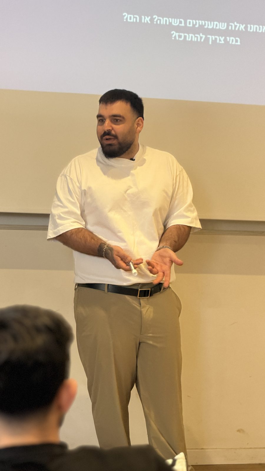 Roni presenting in front of a screen